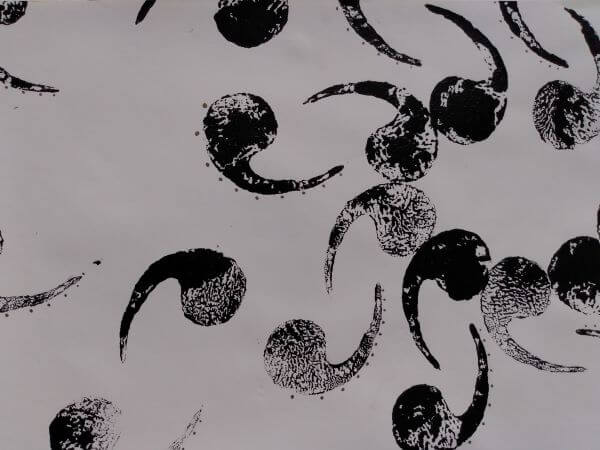 Chocolate curl dessert inspired printed shape in black acrylic paint on white background