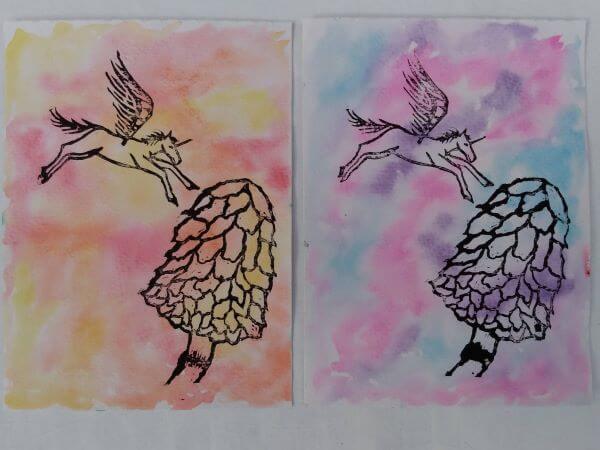 Two prints both with a unicorn flying above a Shaggy Inkcap Mushroom with painted watercolour backgrounds one in shade of pink, blue and purple the other orange, red and yellow